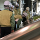 Group of people gathered in his vis jackets and helmets, inspecting brewery