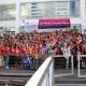 A large group of women posing for a group photo with a banner 'pacific feminist forum 2023: 3rd pacific feminist forum, embracing the collective power of movements'.