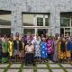 Group of women from the Pacific posing for photograph in courtyard.