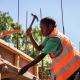 Vanuatu construction worker with hammer in hand on a building site.