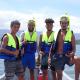 Group photo of 4 PNG boy in a tinnie boat off the coast.