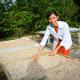 Photo of Ms. Cao Thi Ngoc My drying out soursop grains. 