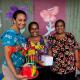 Three women posing for photo outside Able-Disable Centre.