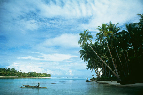 Tropical island and a fisherman in boat