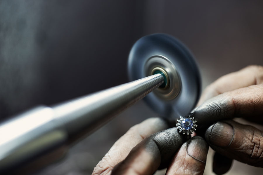 Decorative image of a Jeweller polishing a ring