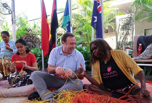 Peter Roberts weaving with master weaver Rene Kulitja.