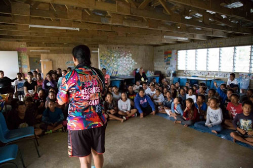 Belinda speaking to a class of children.