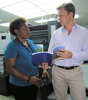 Man and woman holding an English resource book