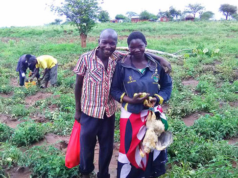  Kimondiu and Damaris working a field with two other people
