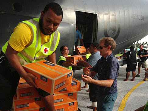People offloading supplies from an airplane.