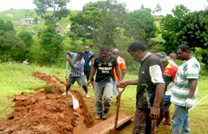 Fijian men constructing flush toilets.