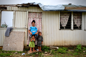 Woman and children standing in front of a house