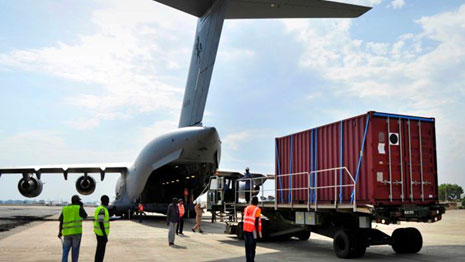 Shipping container being unloaded from plane