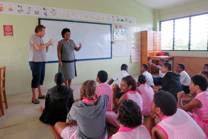 Sera speaking to a group of students in a classroom.