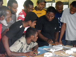 Photo of Rina Alau teaches students about electrical wiring at Australia Pacific Technical College