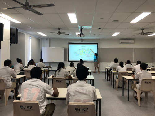 Photo of Venessa speaking to classroom full of students.