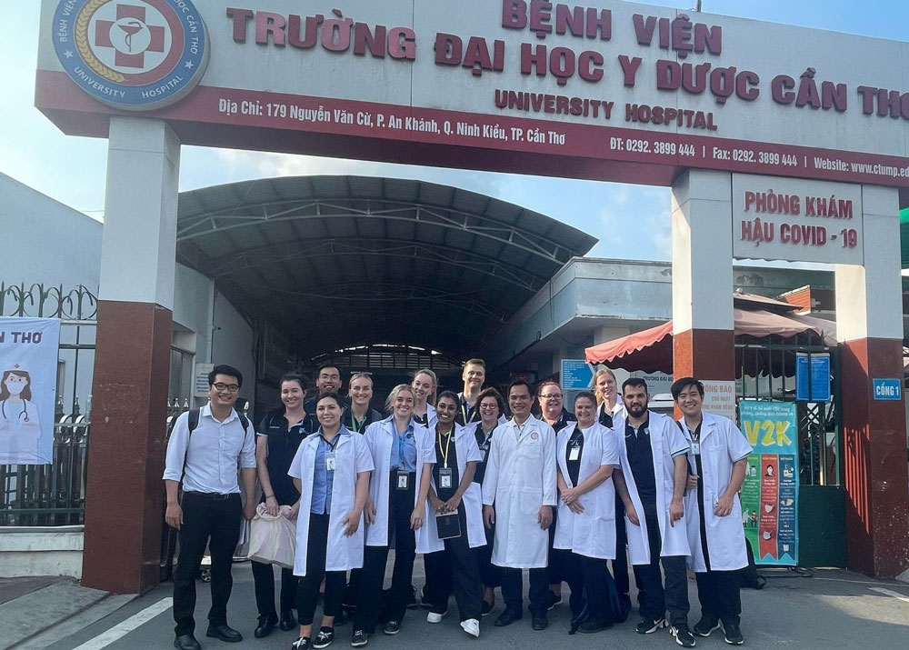 Group photo of the Central Queensland University sonography students in front of a clinic.