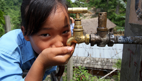 A girl in Nepal drinking clean water from a tap