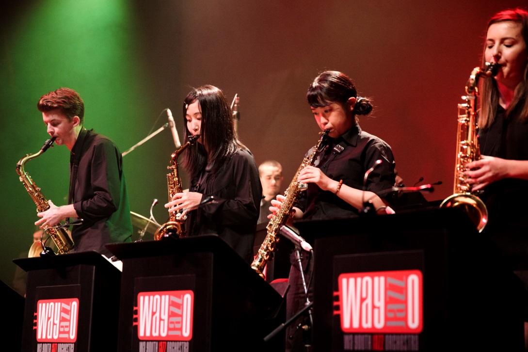  orchestra performing on saxophones