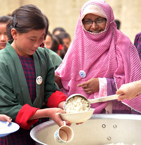 Students having their bowls filled with food