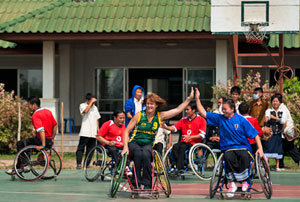 Liesel Tesch hive-fiving a teammate on the basketball court