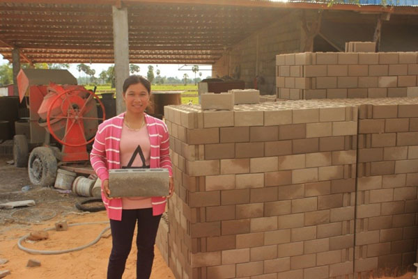 Photo of a person holding a brick.